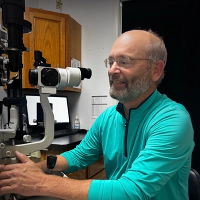 A photo of Dr. Daniel R. Obermark using exam equipment